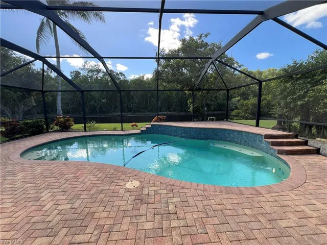 a view of a swimming pool with a patio