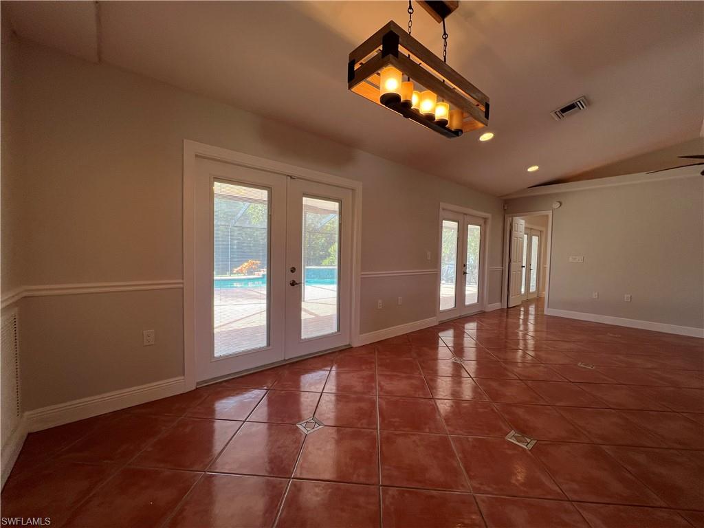4724 32nd Avenue Southwest Naples, FL 34116 - Photo 22 of 39 a view of an empty room with a window and wooden floor