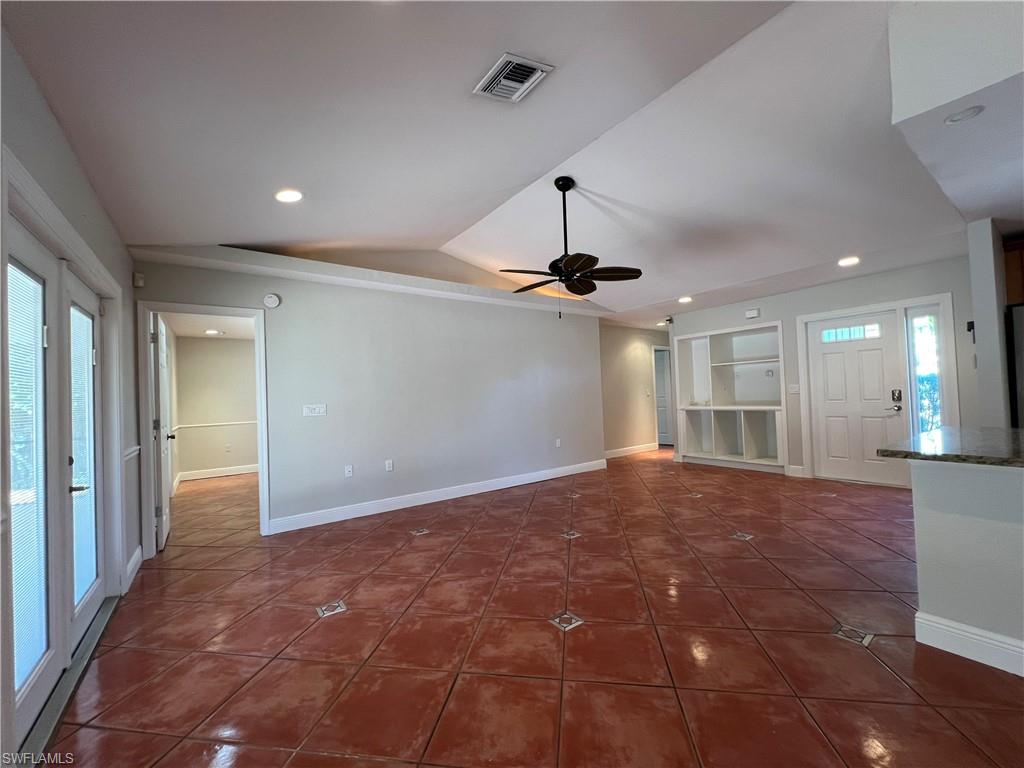 4724 32nd Avenue Southwest Naples, FL 34116 - Photo 23 of 39 a view of an empty room with a chandelier fan and a window