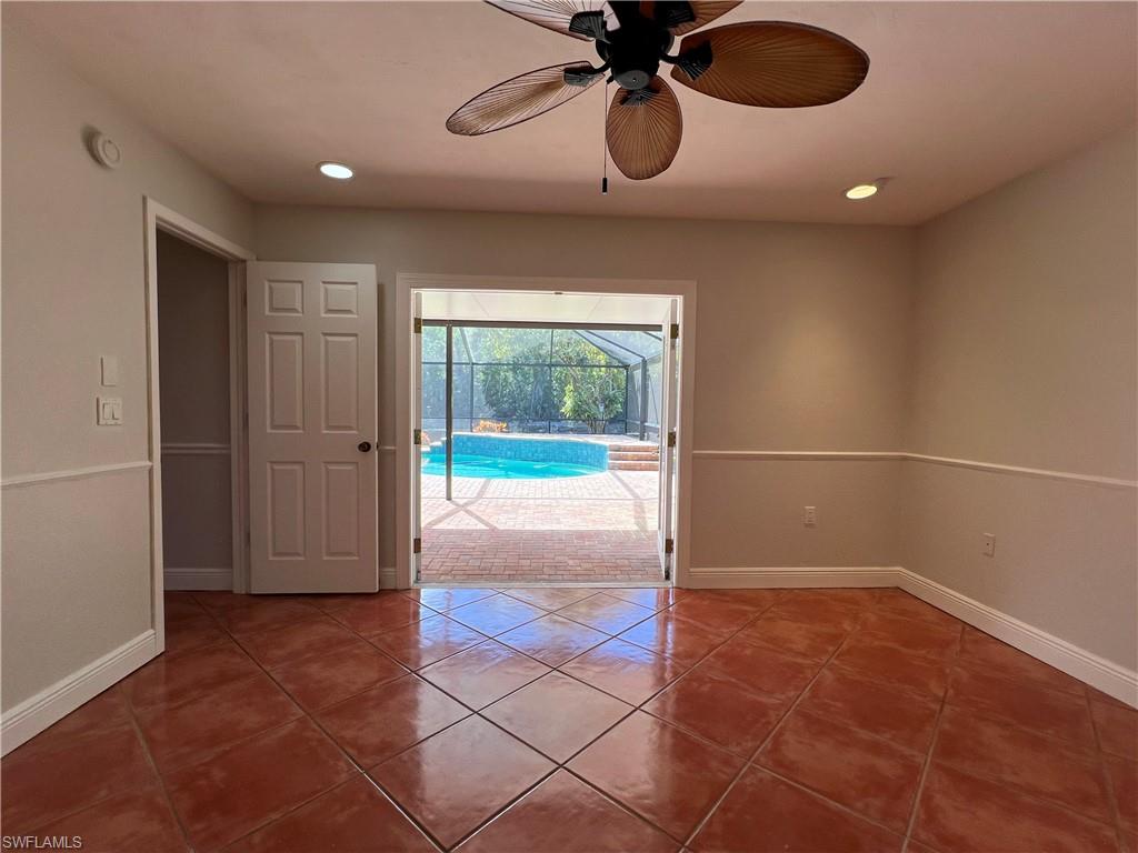 4724 32nd Avenue Southwest Naples, FL 34116 - Photo 25 of 39 a view of a livingroom with a chandelier fan and kitchen view