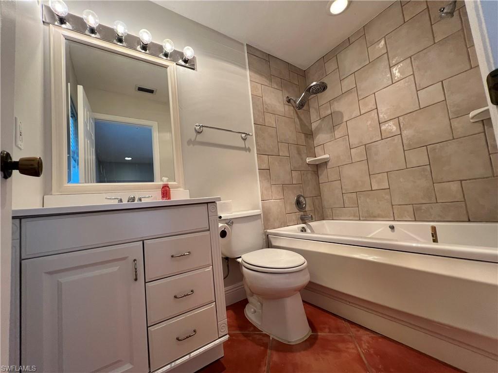 4724 32nd Avenue Southwest Naples, FL 34116 - Photo 28 of 39 a bathroom with a sink toilet a mirror and shower