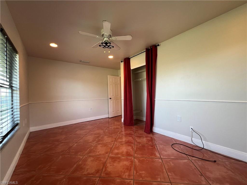 4724 32nd Avenue Southwest Naples, FL 34116 - Photo 30 of 39 an empty room with fan and windows