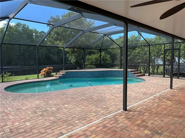 a backyard of a house with table and chairs