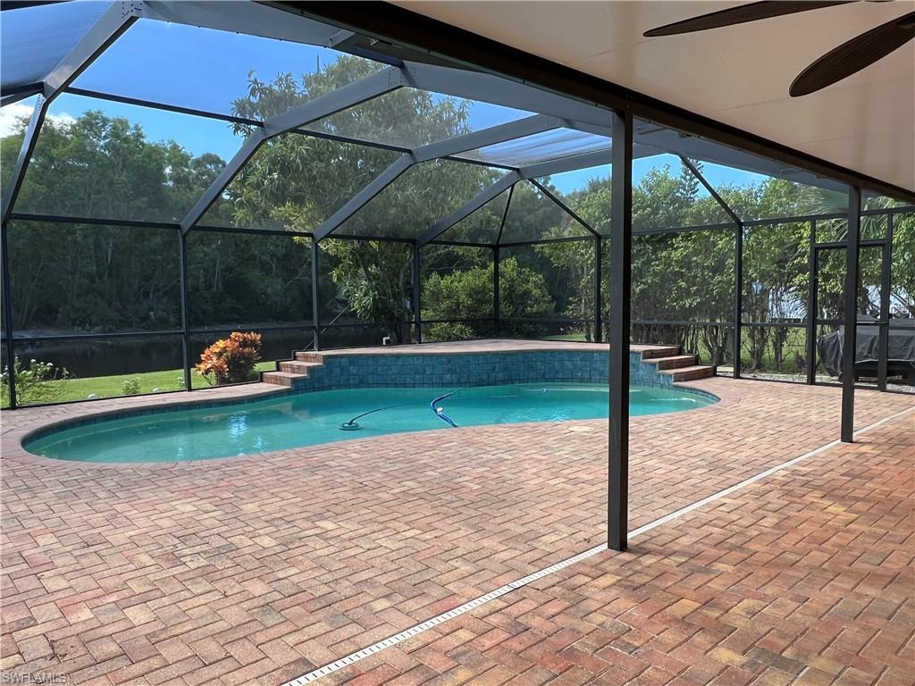 4724 32nd Avenue Southwest Naples, FL 34116 - Photo 3 of 39 a backyard of a house with table and chairs