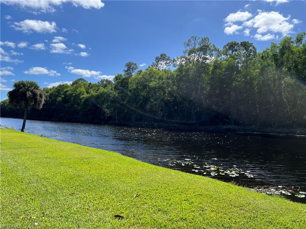4724 32nd Avenue Southwest Naples, FL 34116 - Photo 37 of 39 a view of a swimming pool with an outdoor space and seating area