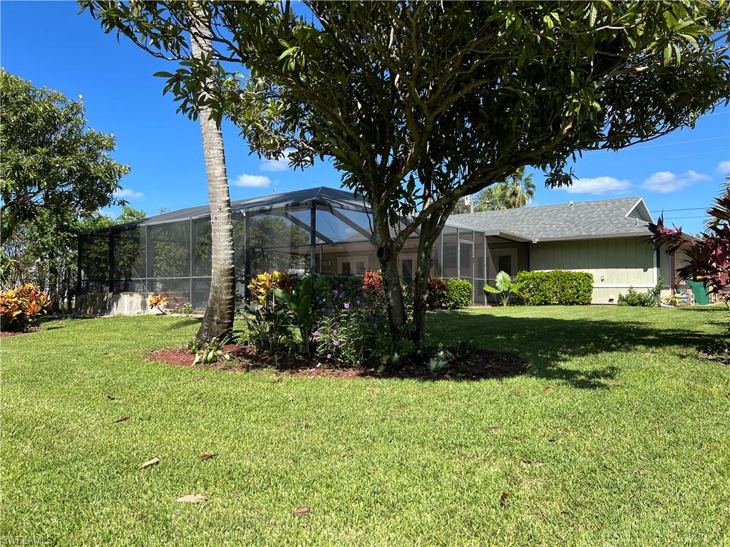 4724 32nd Avenue Southwest Naples, FL 34116 - Photo 38 of 39 a view of a garden with a tree