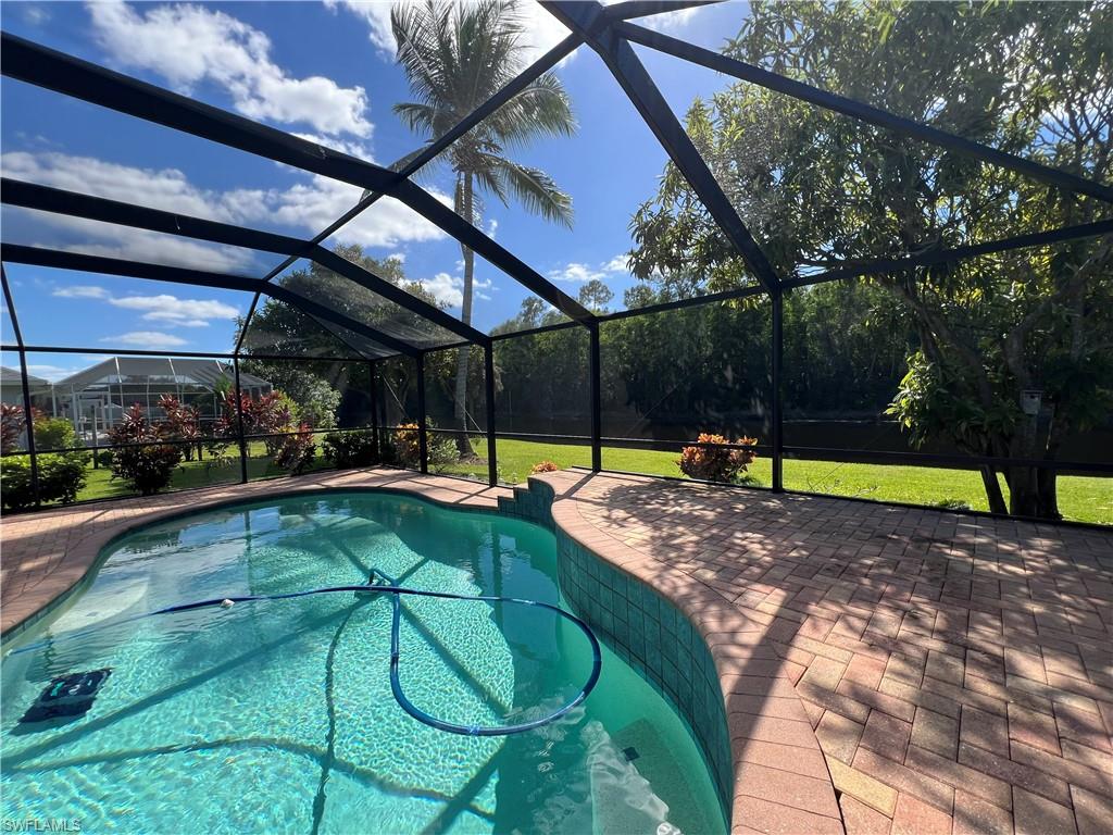 4724 32nd Avenue Southwest Naples, FL 34116 - Photo 4 of 39 a view of a swimming pool with a patio and a backyard