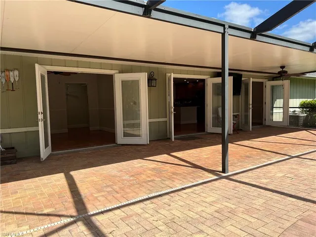 a view of a house with a backyard and sitting area