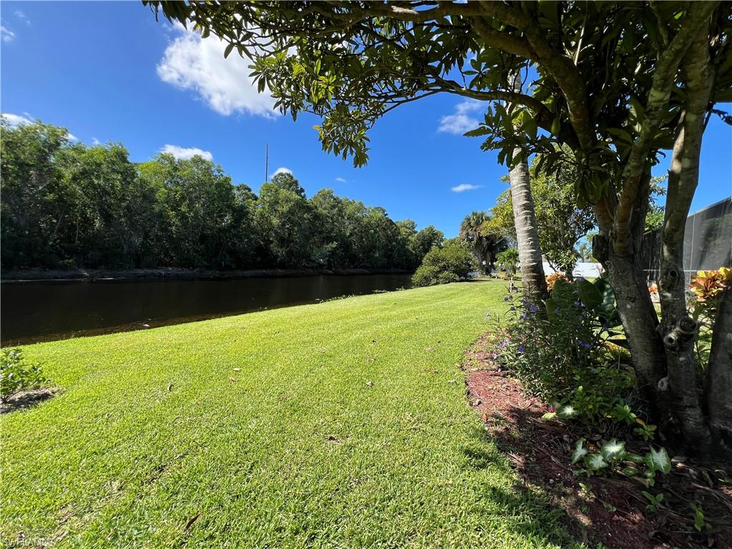 4724 32nd Avenue Southwest Naples, FL 34116 - Photo 10 of 39 a view of yard with swimming pool and green space