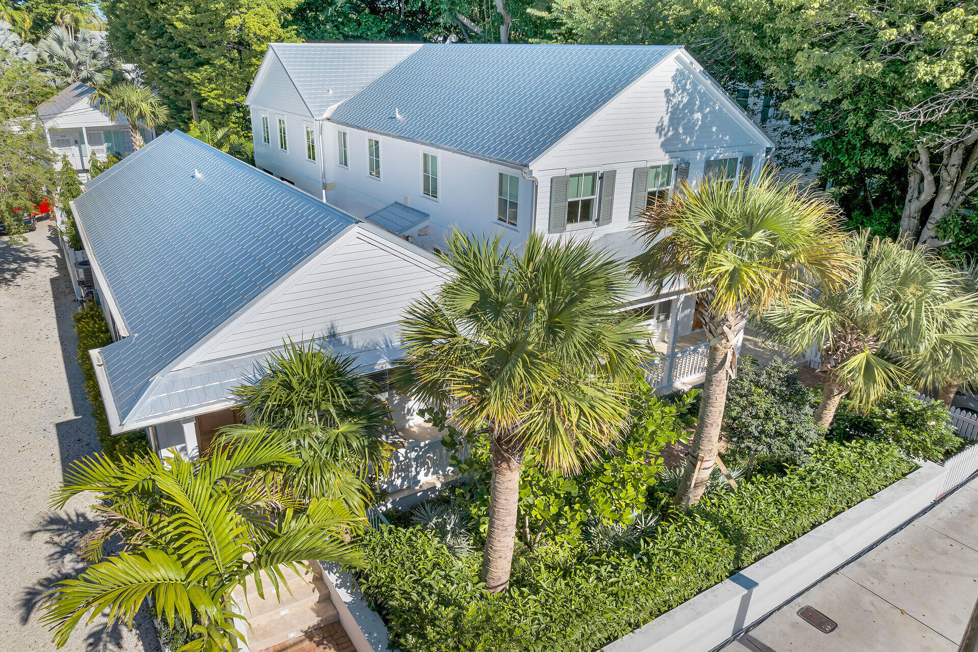 a aerial view of a house with a yard and potted plants