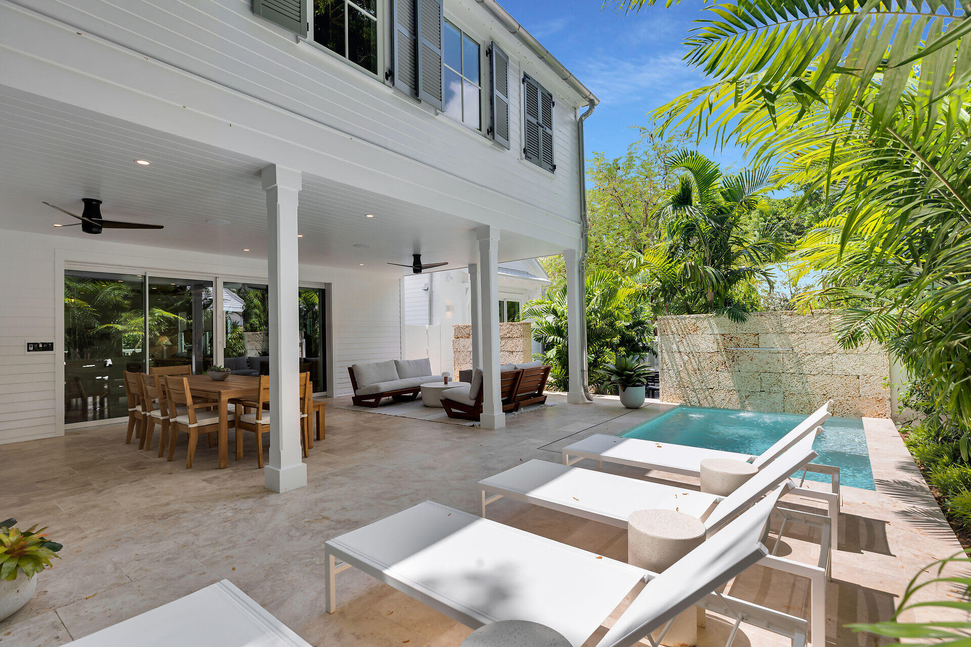 317 Whitehead Street Key West, FL 33040 - Photo 34 of 78 a backyard of a house with outdoor seating
