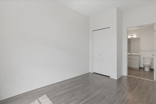 a view of a room with wooden floor and a sink