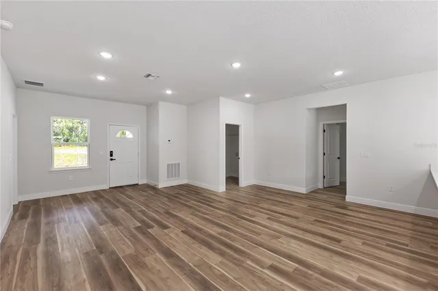 a view of a kitchen with stainless steel appliances wooden floor and a counter top space