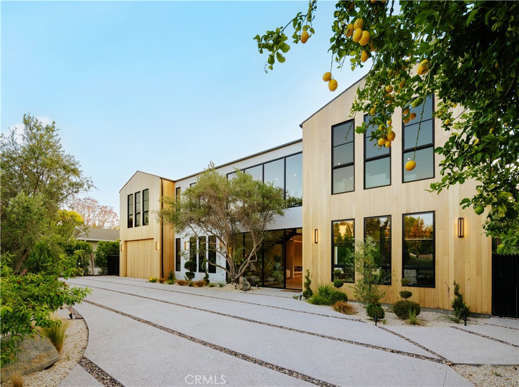 a front view of a building with a garden