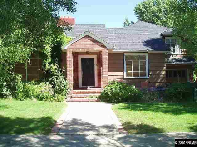 675 Manor Drive Reno, NV 89509 - Photo 1 of 9 a front view of a house with a yard and potted plants