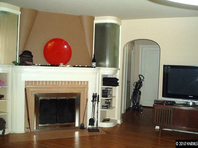675 Manor Drive Reno, NV 89509 - Photo 4 of 9 a living room with fireplace furniture and a flat screen tv