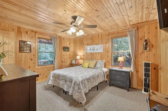 a bedroom with a large bed and a chandelier