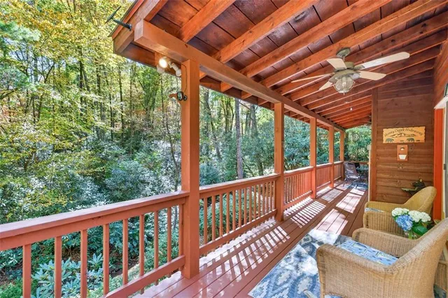 a view of a porch with furniture and wooden floor