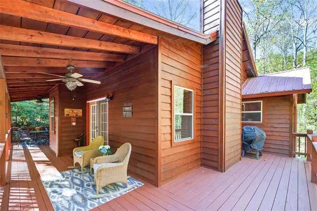 a view of a patio with table and chairs and wooden floor