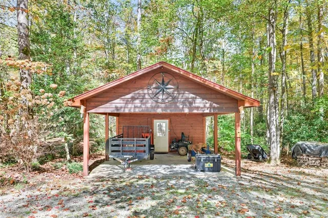 a view of a patio with table and chairs under an umbrella next to a yard