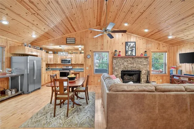 a living room with furniture a fireplace and a table