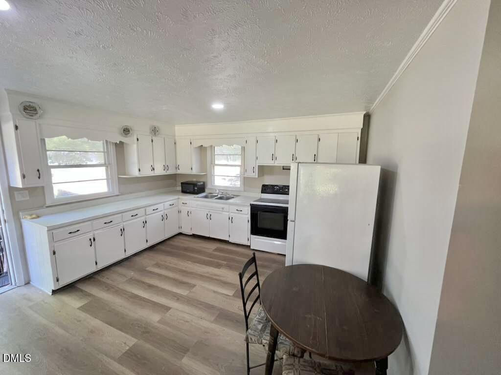 185 Summerhill Road Turkey, NC 28393 - Photo 5 of 18 a kitchen with stainless steel appliances a refrigerator sink and cabinets