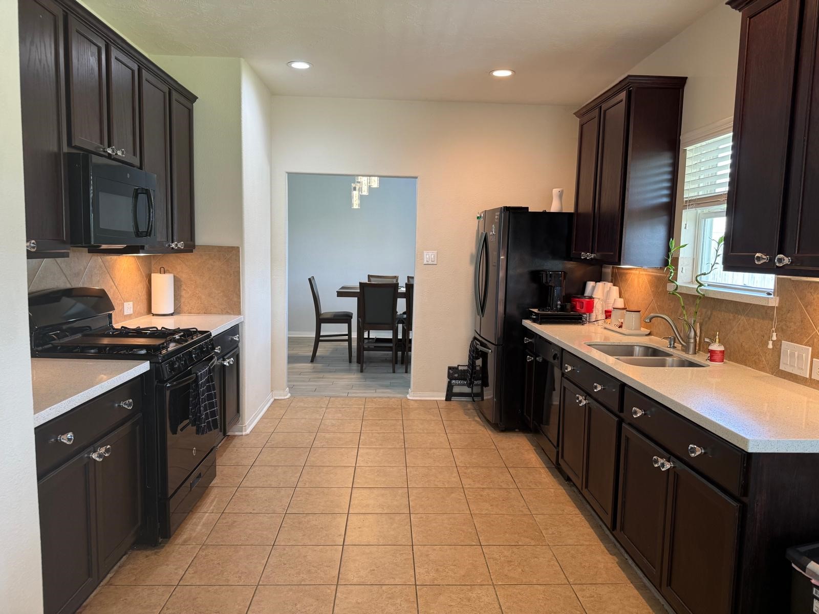 22730 Sunset Glen Lane Spring, TX 77373 - Photo 3 of 7 a kitchen with stainless steel appliances granite countertop a refrigerator stove and sink