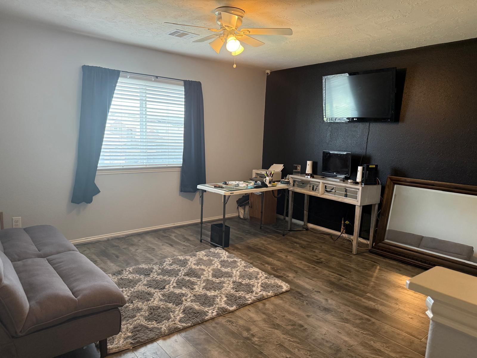 22730 Sunset Glen Lane Spring, TX 77373 - Photo 4 of 7 a living room with furniture and a flat screen tv