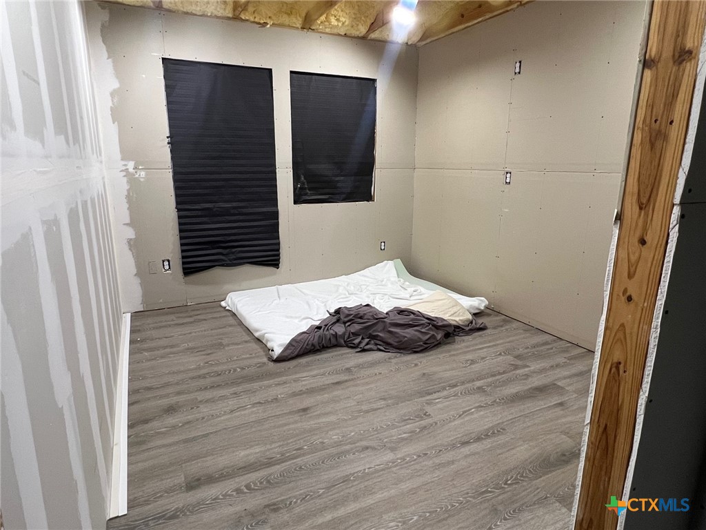 9 Lee Street Port Lavaca, TX 77979 - Photo 6 of 11 a bedroom with a bed and wooden floor