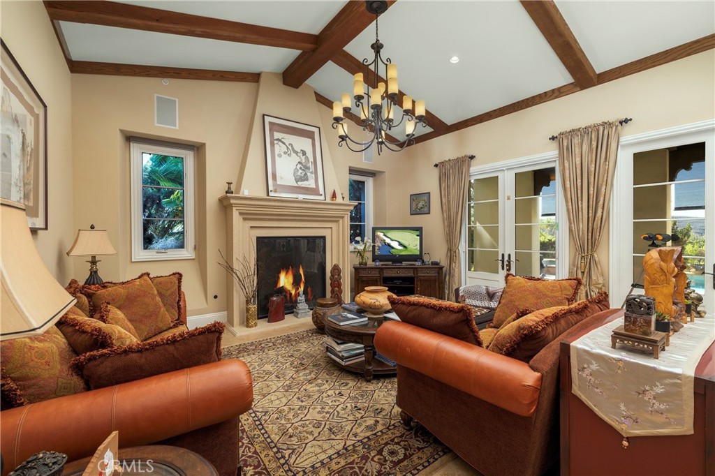 47 Vernal Irvine, CA 92603 - Photo 13 of 38 a living room with furniture a chandelier and a fireplace