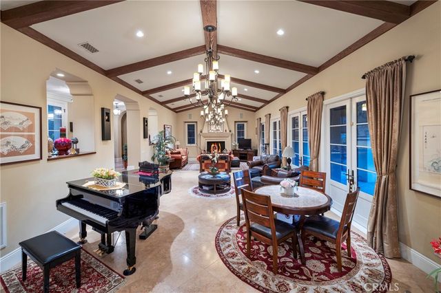 a living room with furniture a chandelier and a rug