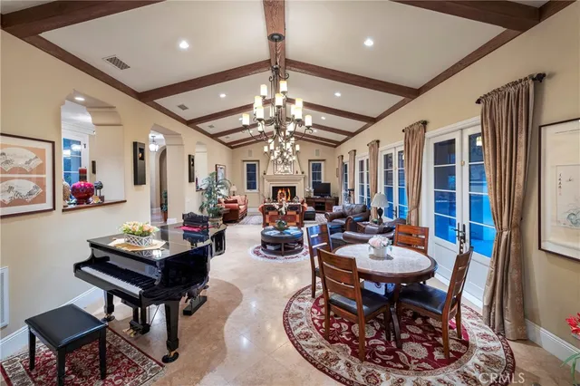 a living room with furniture a chandelier and a rug