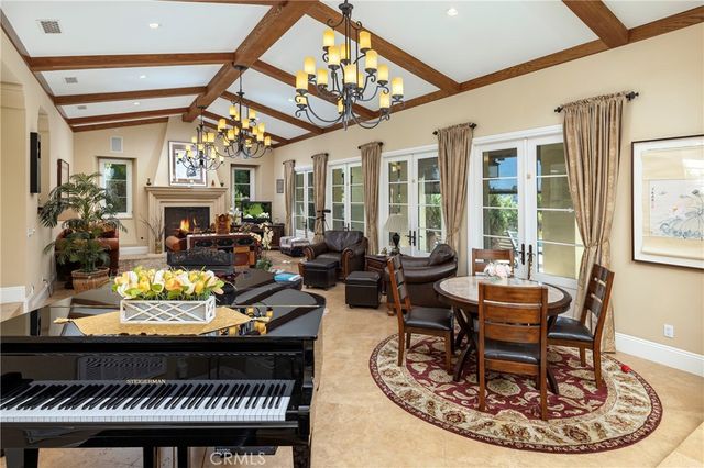 a living room with furniture a chandelier and a rug