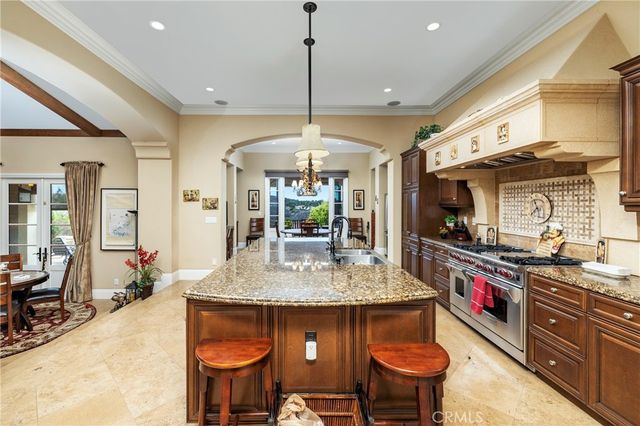 a kitchen with stainless steel appliances granite countertop a stove a sink and a refrigerator