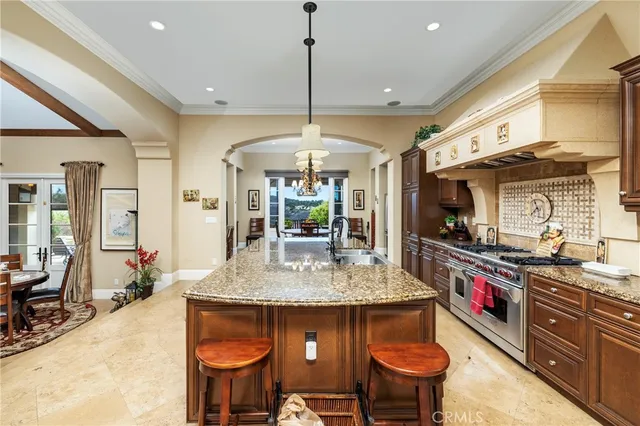 a kitchen with stainless steel appliances granite countertop a stove a sink and a refrigerator