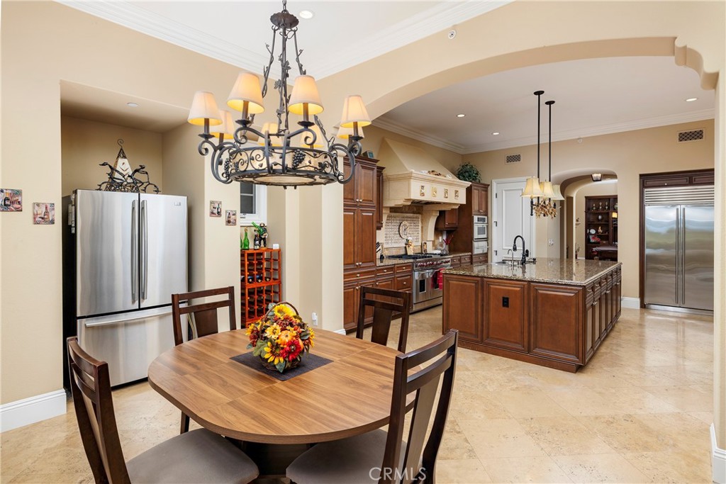 47 Vernal Irvine, CA 92603 - Photo 22 of 38 a kitchen with refrigerator a sink dining table and chairs