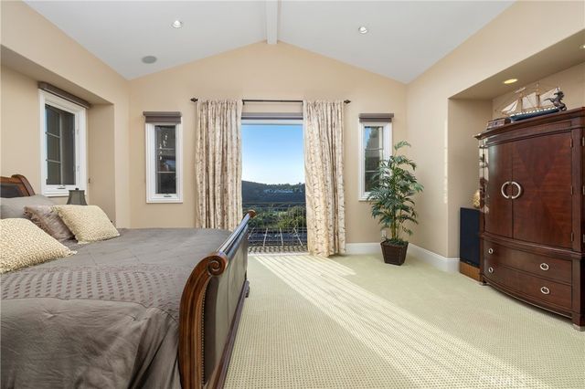 a bedroom with a bed and potted plants