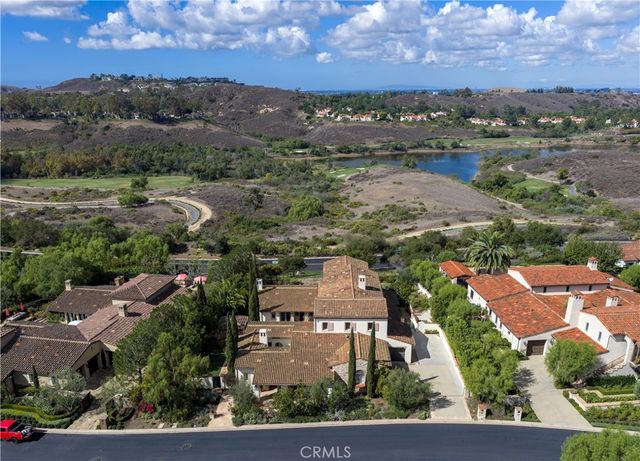 an aerial view of residential houses with outdoor space and ocean view
