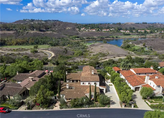 an aerial view of residential houses with outdoor space and ocean view