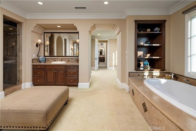 a large bathroom with a large tub and sink