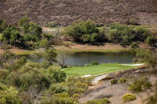 an aerial view of a golf course with a lake view
