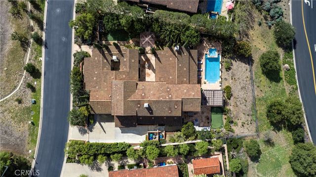 an aerial view of a house with a yard and garden