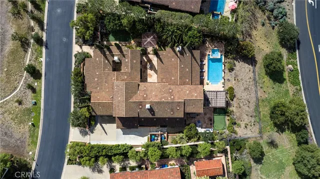 an aerial view of a house with a yard and garden