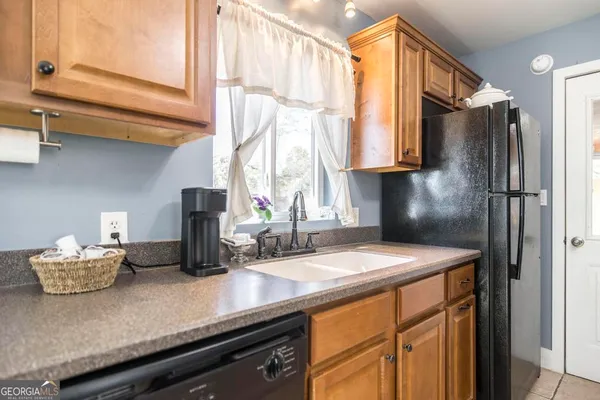 a kitchen with appliances cabinets and a counter top space