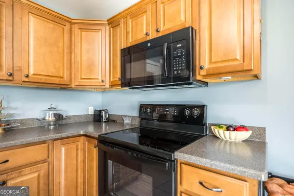a kitchen with stainless steel appliances granite countertop a stove and a microwave