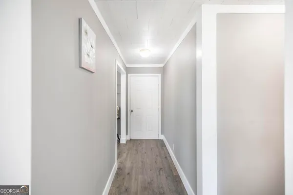 a view of a hallway with wooden floor