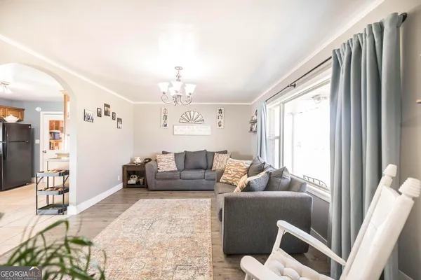 a living room with furniture and a chandelier