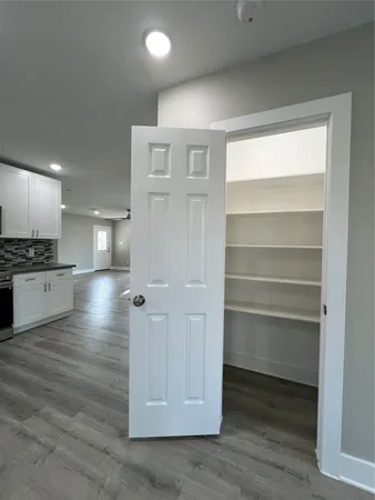 an empty room with a wooden floor and a window