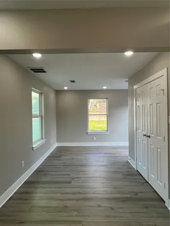 a kitchen with granite countertop white cabinets and a sink