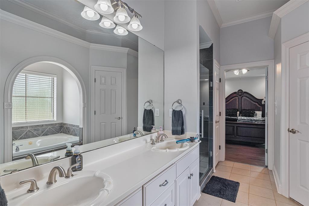 102 Fitzwilliam Street Haughton, LA 71037 - Photo 12 of 18 a bathroom with a sink a large mirror and a shower